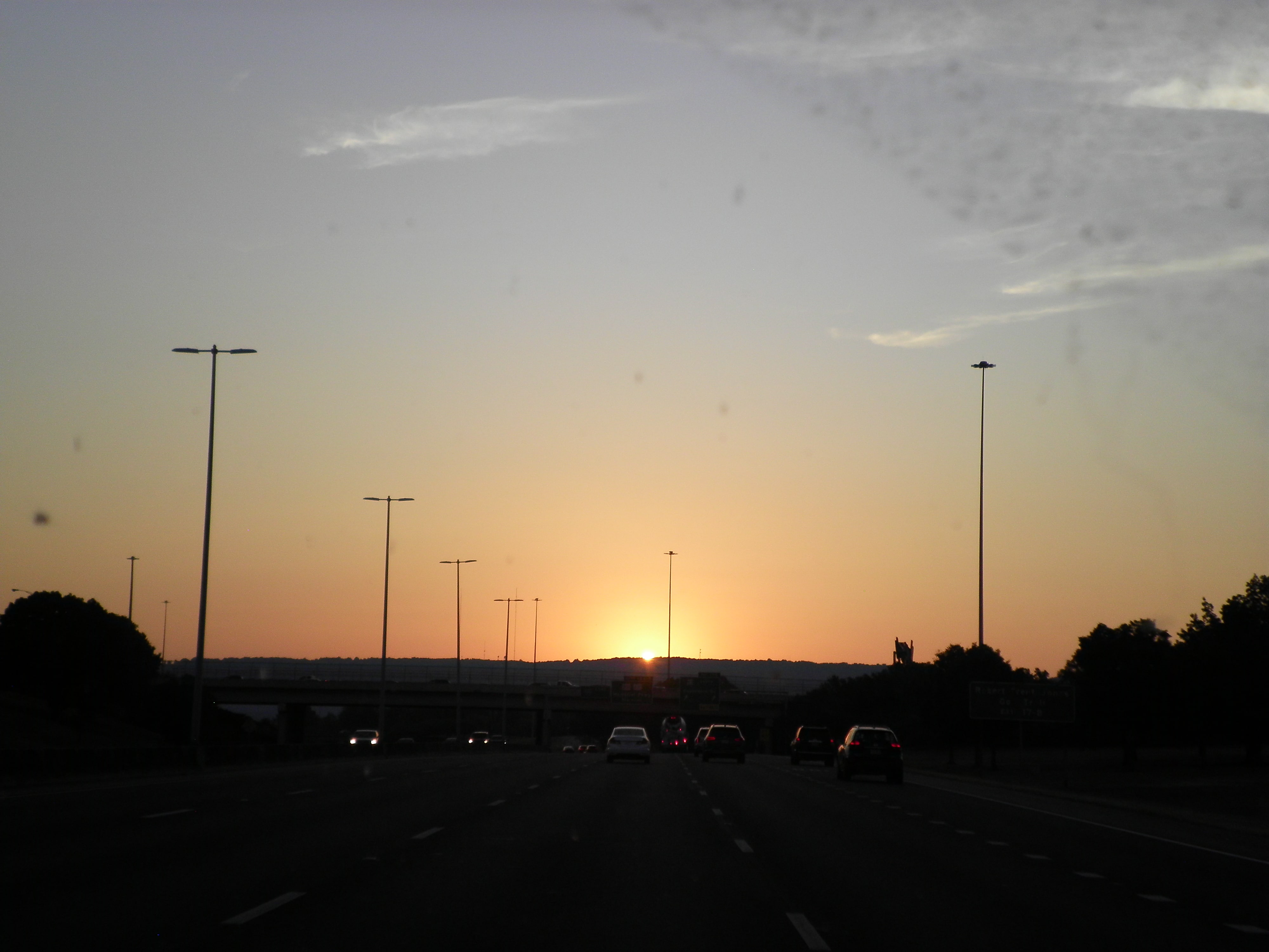 sunrise from a car on a highway