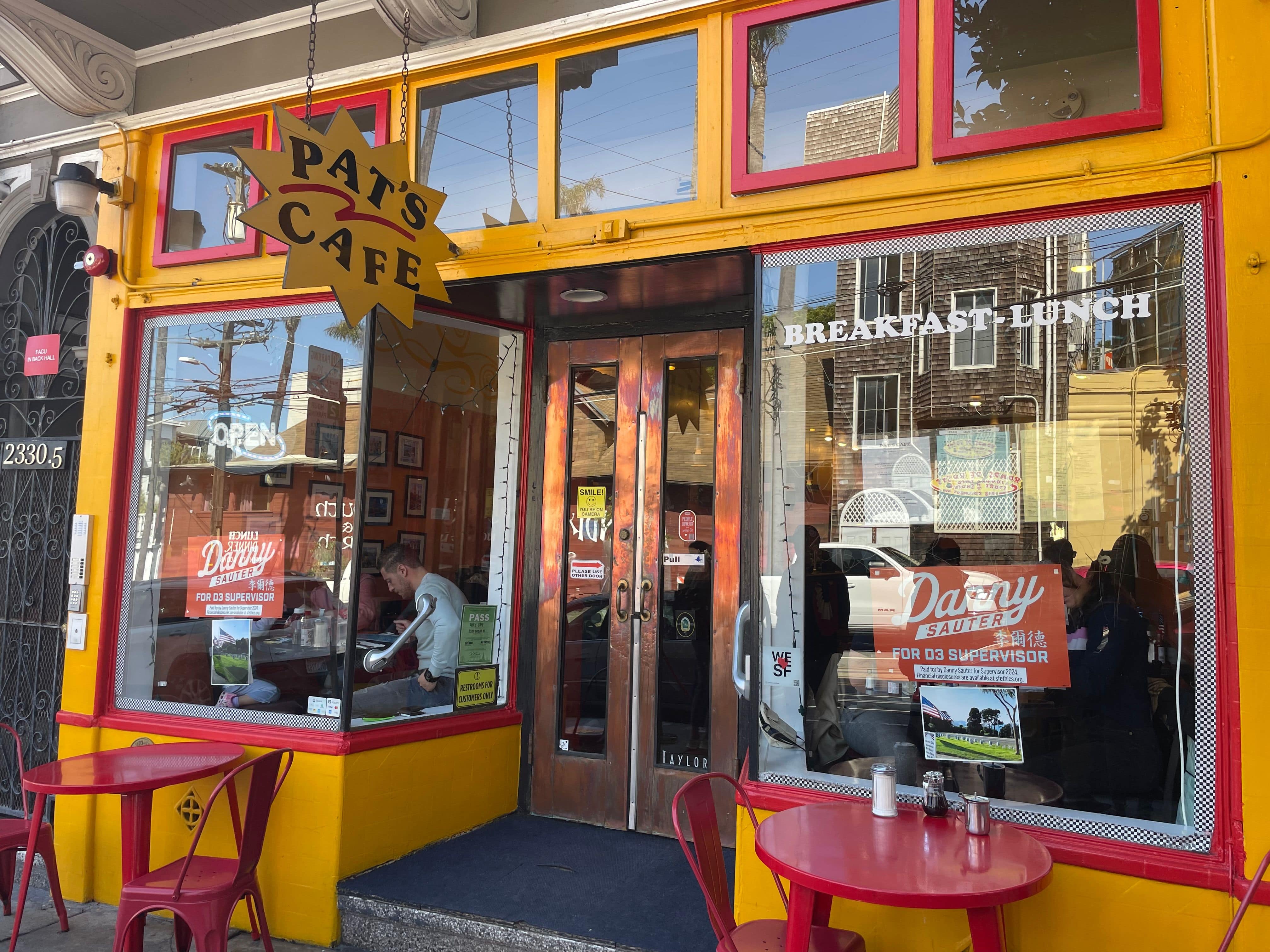 picture of a store with a yellow exterior and red trim named pat's cafe